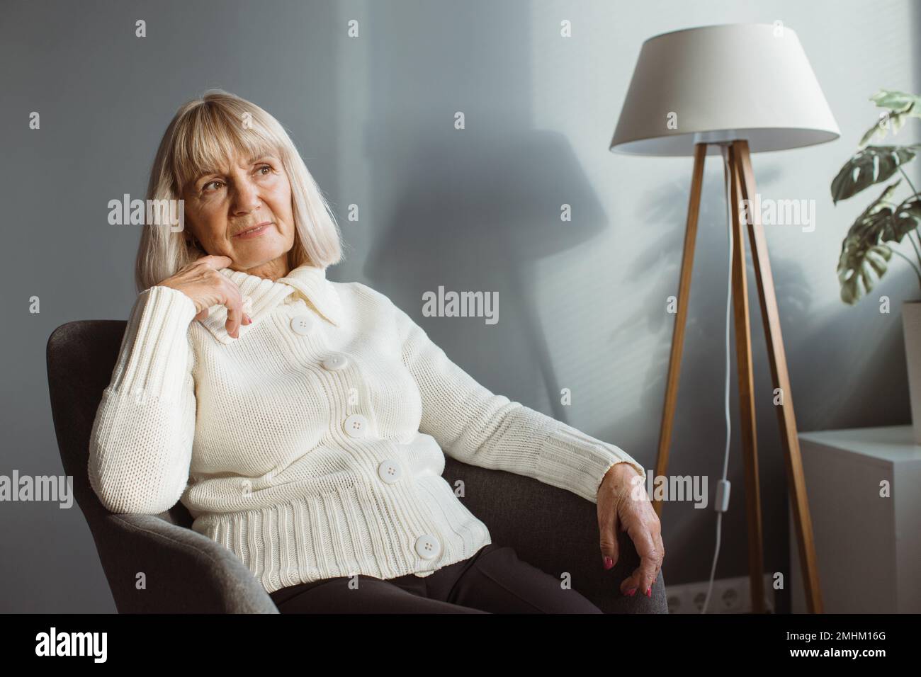 Portrait Of Senior Woman Relaxing In Chair Stock Photo - Alamy