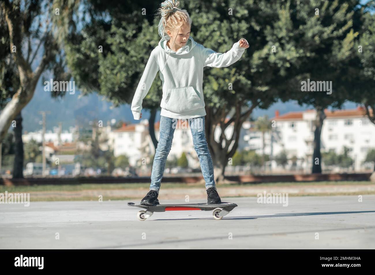 Girl riding on waveboard with two wheels, modern street skate sports of