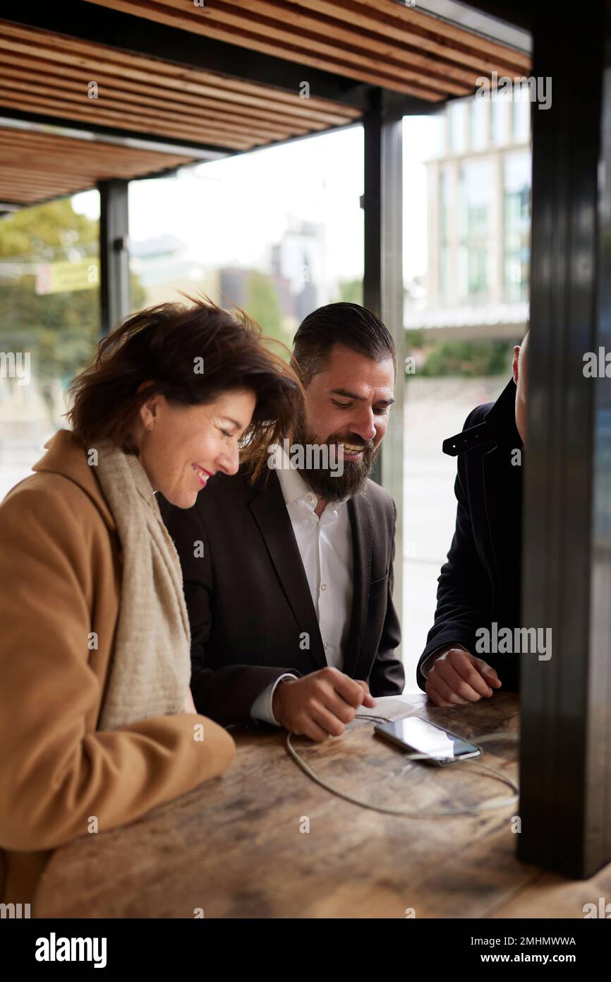 Smiling business people talking together Stock Photo