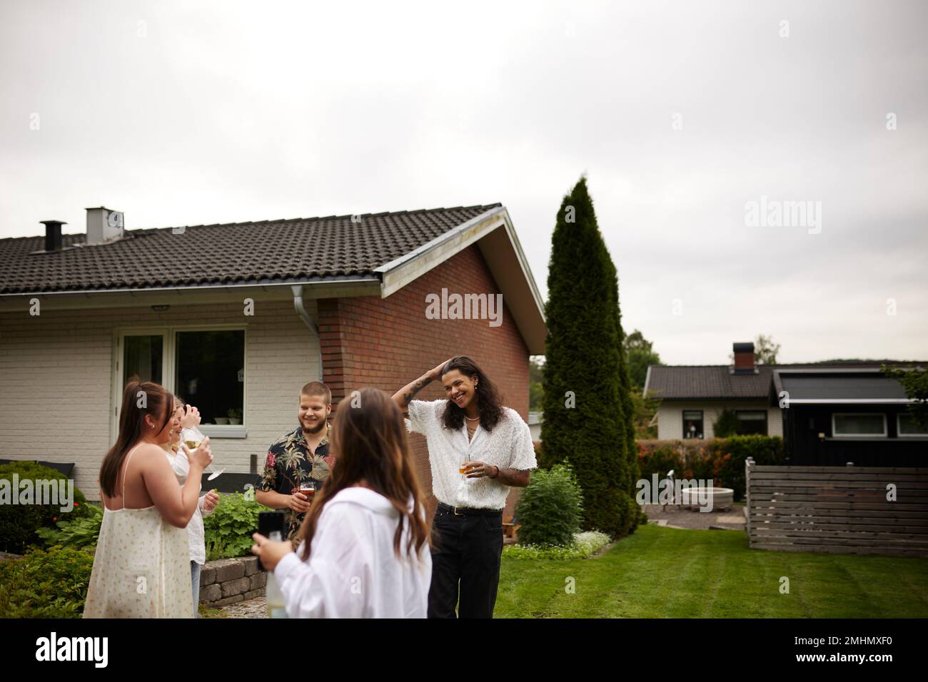 Smiling friends talking in garden Stock Photo