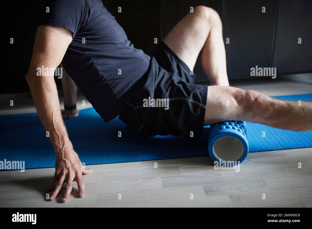 Man stretching and warming up using foam roller Stock Photo Alamy