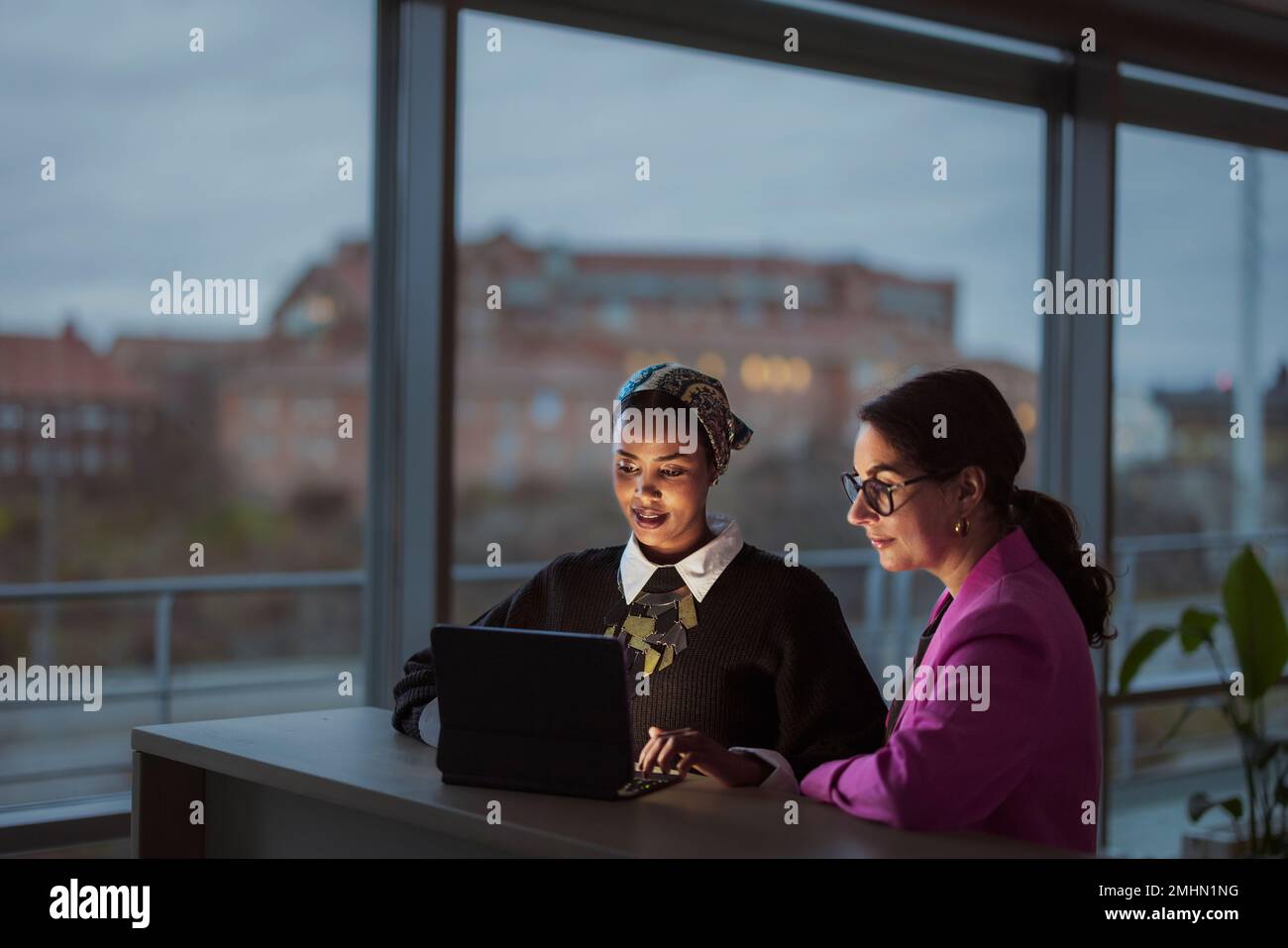 Women working together on laptop Stock Photo