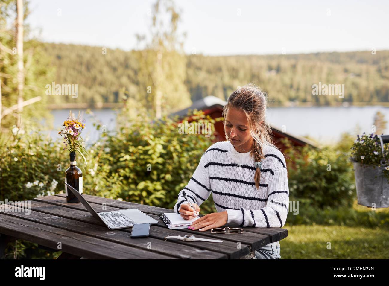 Smiling woman taking notes Stock Photo