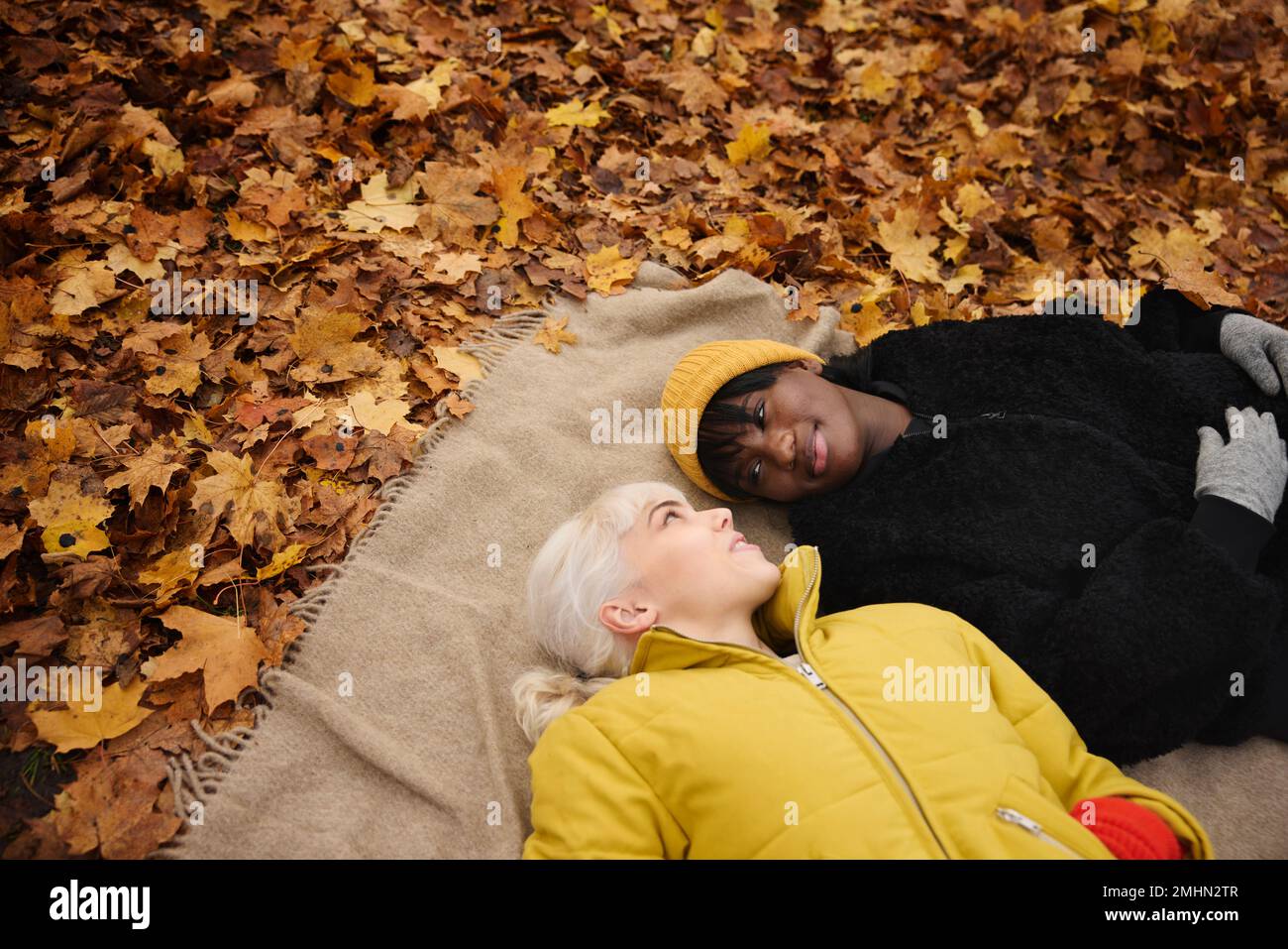 Female friends lying together Stock Photo