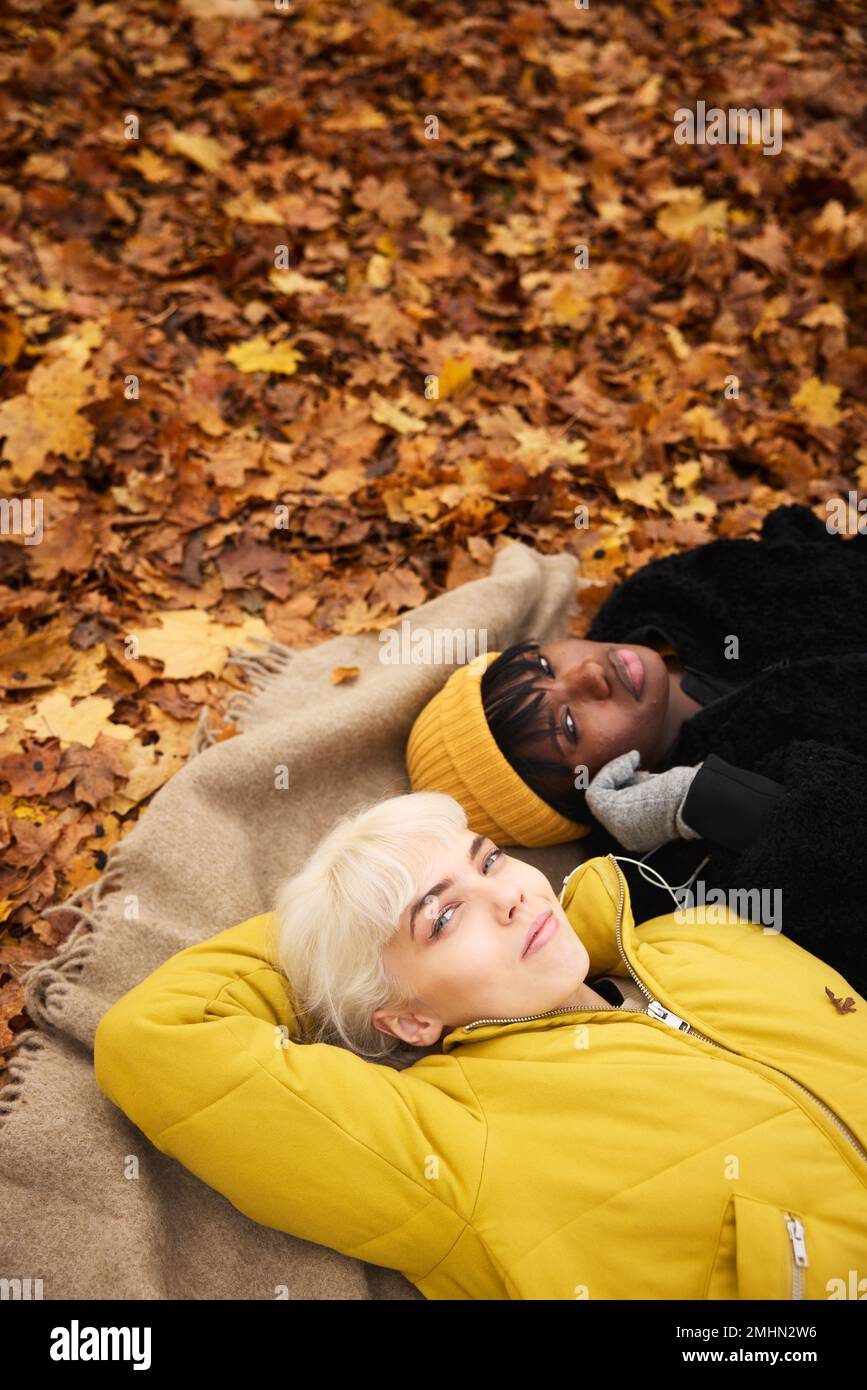 Female friends lying together Stock Photo
