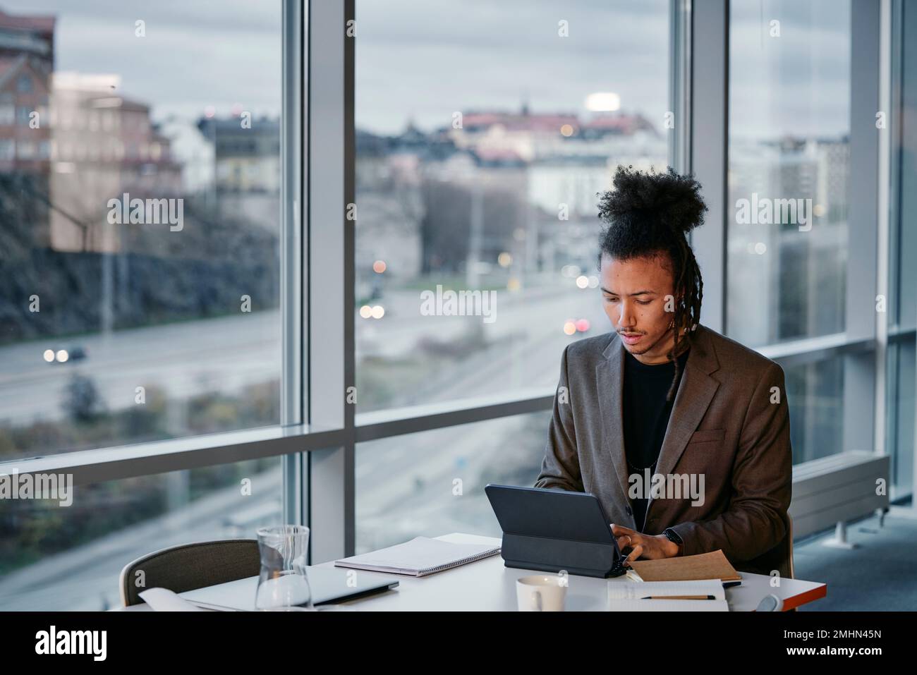 Young businessman using tablet in office Stock Photo