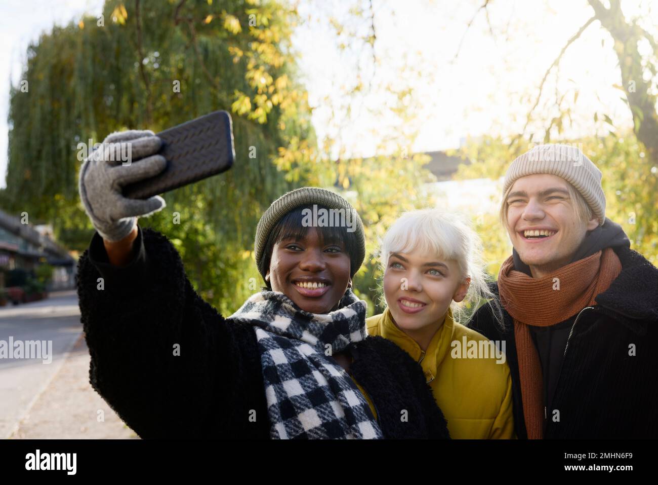 Smiling young friends taking selfie Stock Photo