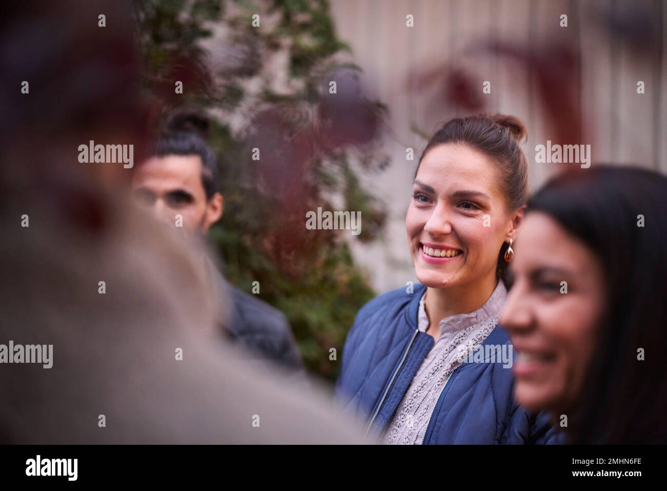 Smiling friends talking in garden Stock Photo