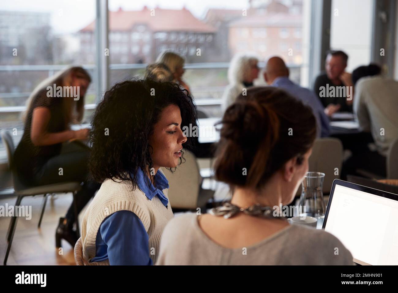 Women talking in cafeteria Stock Photo