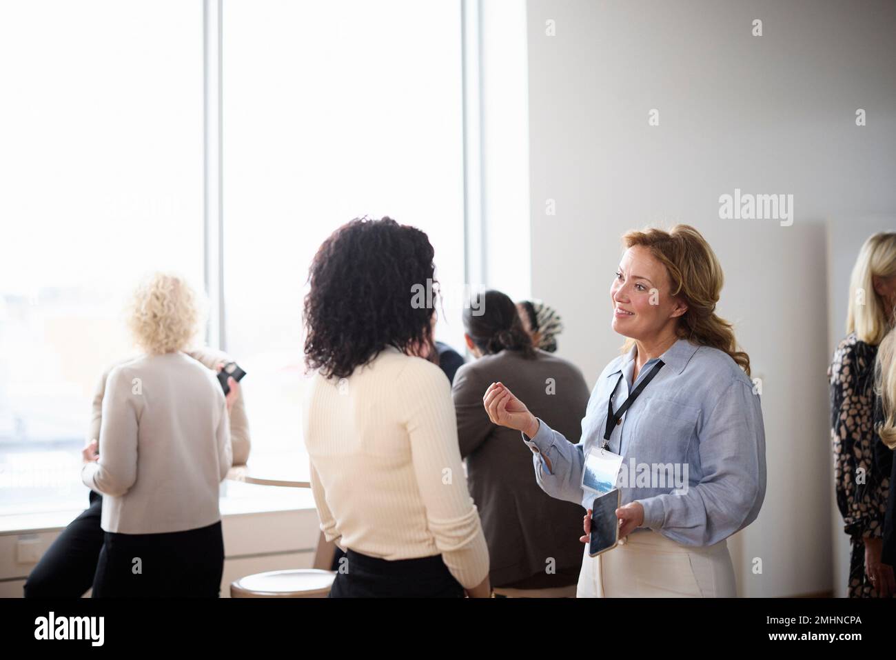 Businesswomen talking during coffee break Stock Photo