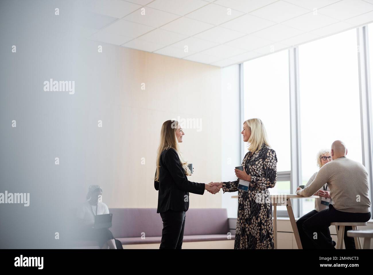 Businesswomen talking during coffee break Stock Photo
