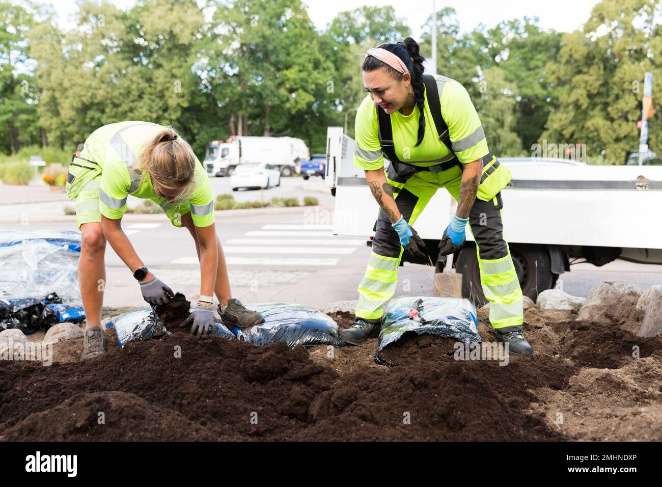 Female workers doing landscaping work Stock Photo