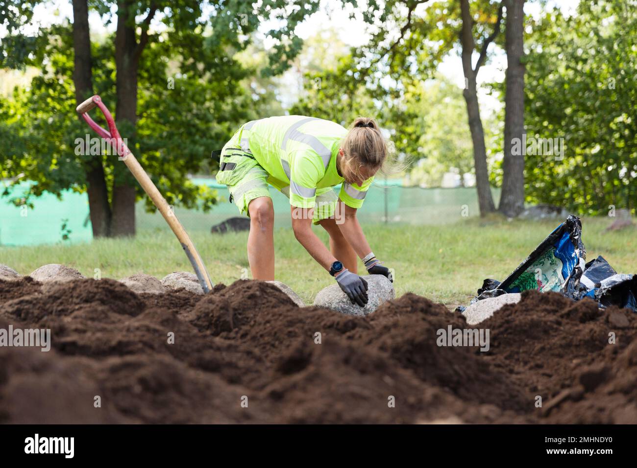 Female worker doing landscaping work Stock Photo