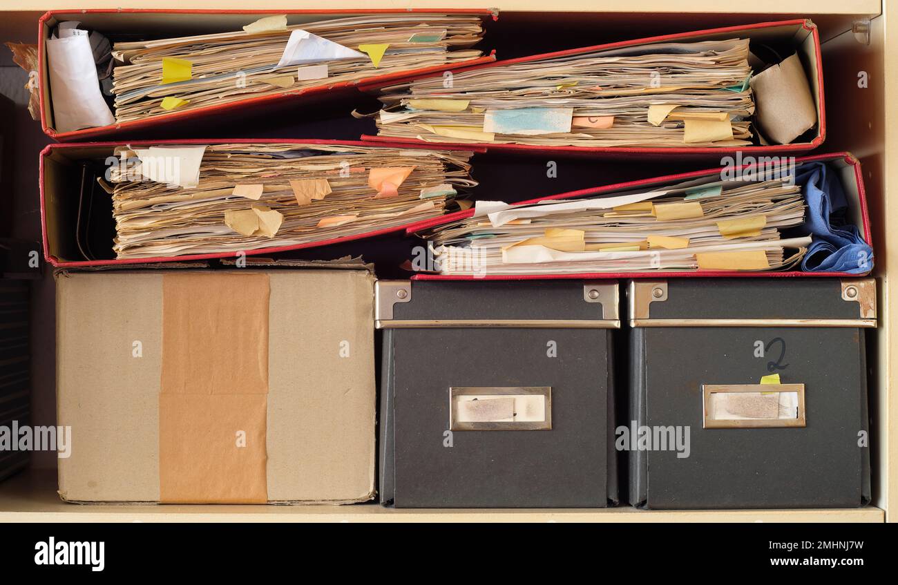 Row of messy file folders,red tape,close up, bureaucracy,aministration,business concept Stock Photo
