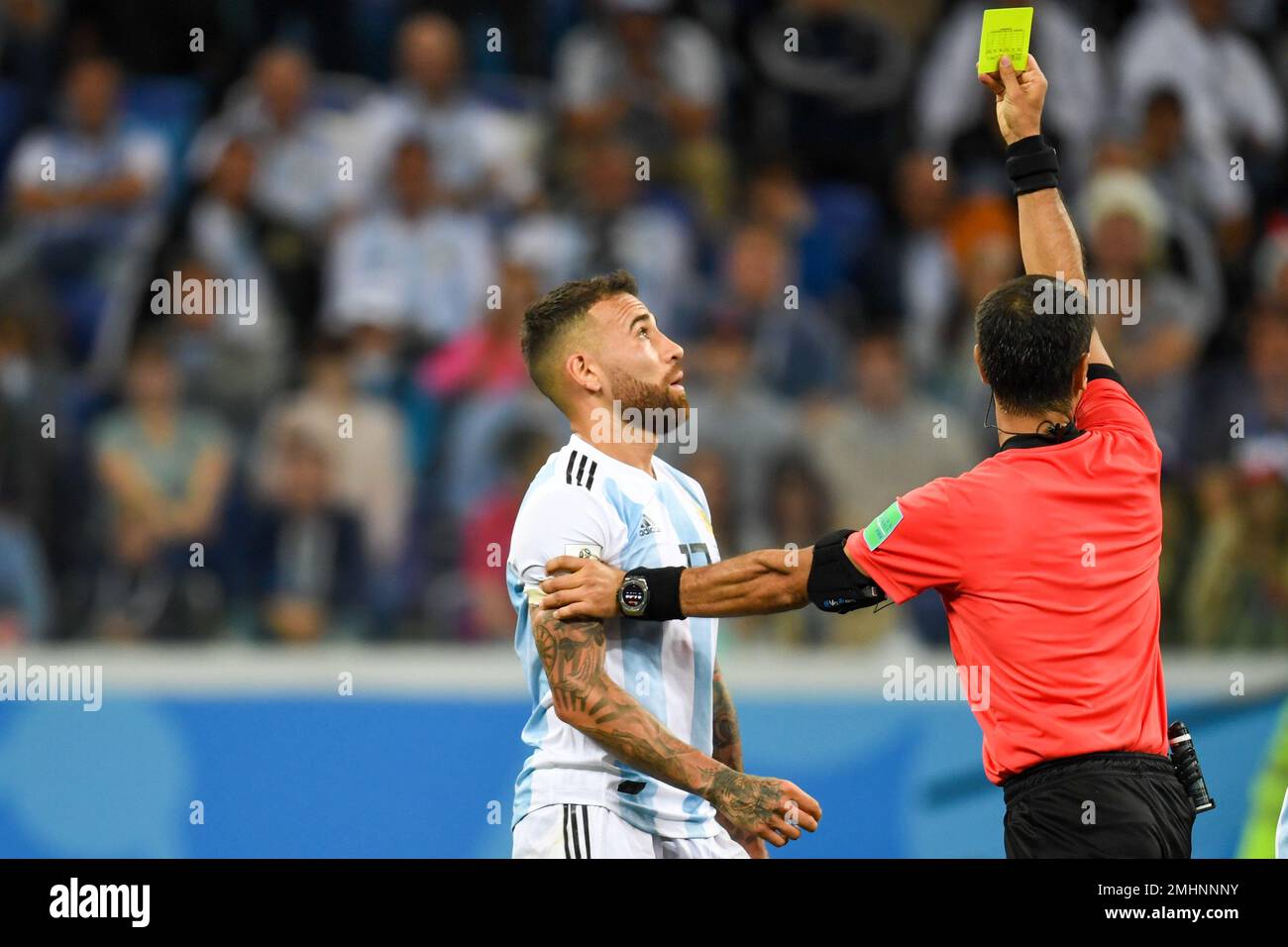 NIZHNY NOVGOROD, RUSSIA - JUNE 21: Nicolas Otamendi of Argentina is shown a yellow card by referee Ravshan Irmatov during the 2018 FIFA World Cup Stock Photo
