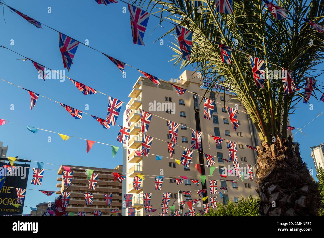 Palm tree and union jack flags in Benidorm, Spain Stock Photo