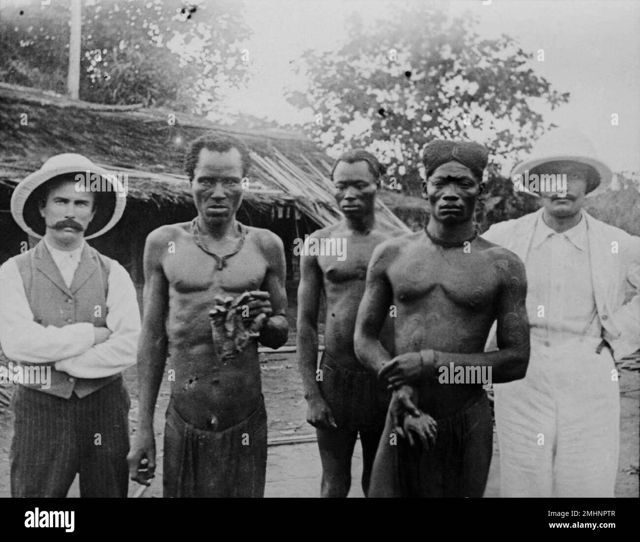 Picture of 'Congolese men holding cut off hands' Stock Photo