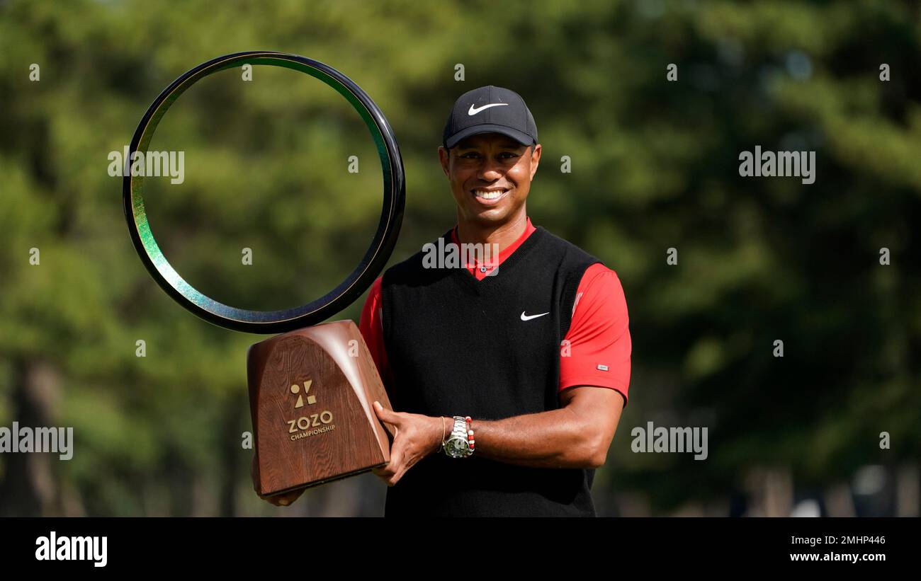 Tiger Woods of the United States poses with his trophy after winning the Zozo Championship PGA Tour at the Accordia Golf Narashino country club in Inzai, east of Tokyo, Japan, Monday, Oct.