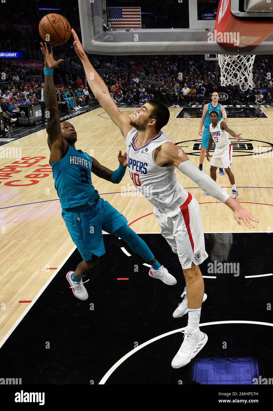 Charlotte Hornets guard Terry Rozier, left, shoots while Los Angeles ...