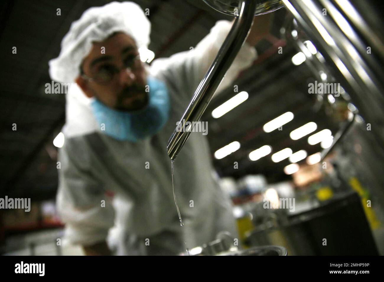 In this April 12 2019 photo an employee checks the alcohol