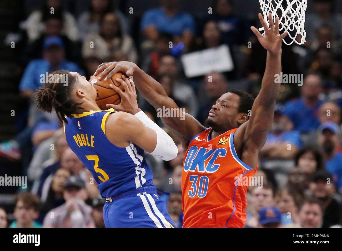 Oklahoma City Thunder guard Deonte Burton (30) gets his hand on the ball  and forces a jump ball with Golden State Warriors guard Jordan Poole, left,  in the second half of an