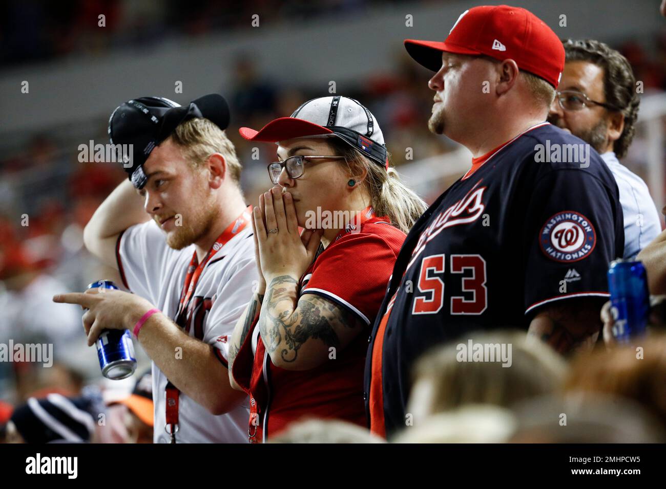 Fans watch during the ninth inning of Game 5 of the baseball World Series between the Houston Astros and the Washington Nationals Sunday, Oct
