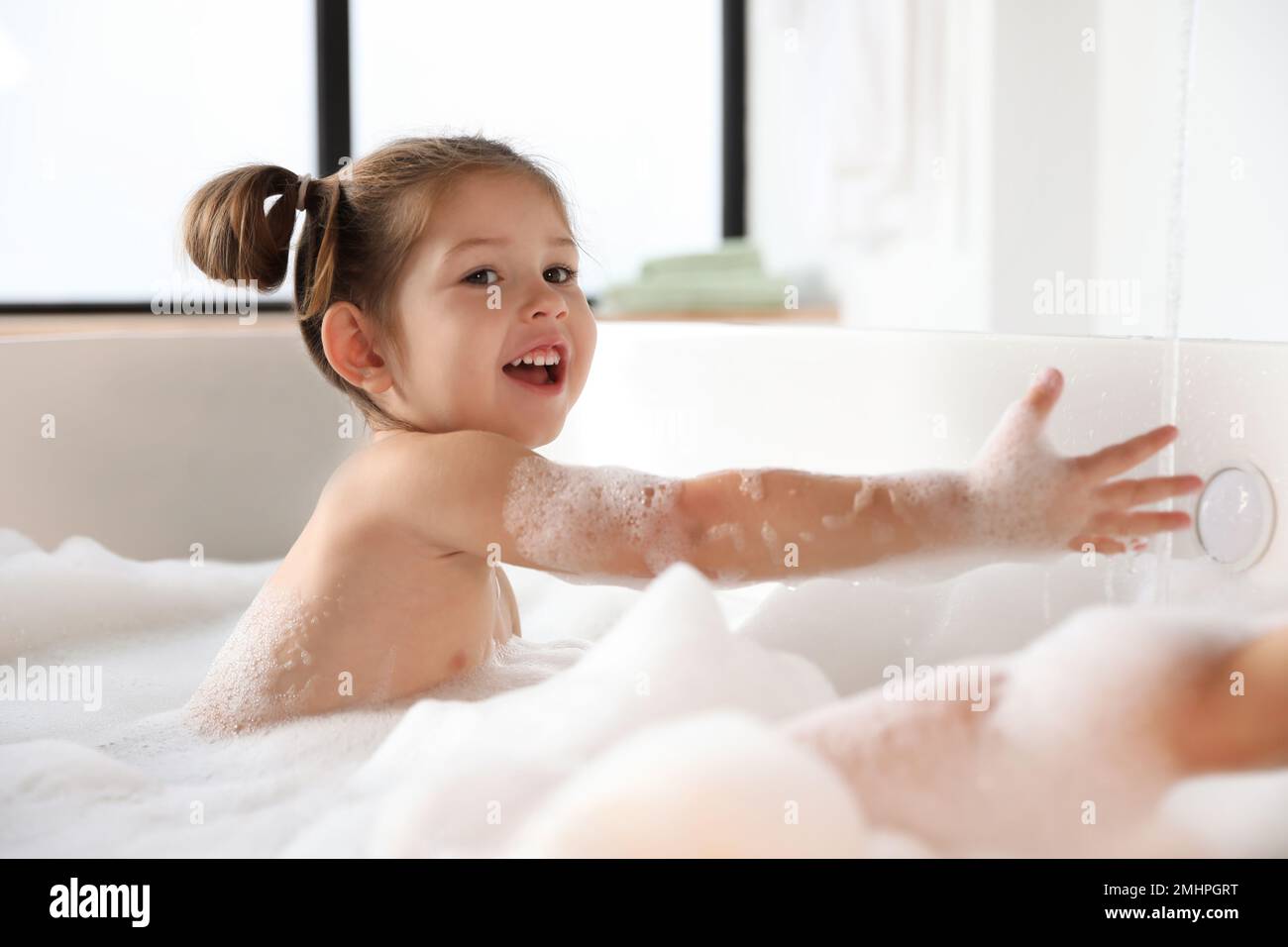 Cute little girl taking bubble bath at home Stock Photo Alamy