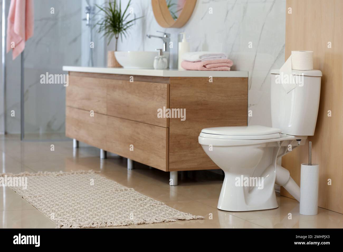 Interior of modern bathroom with toilet bowl Stock Photo - Alamy