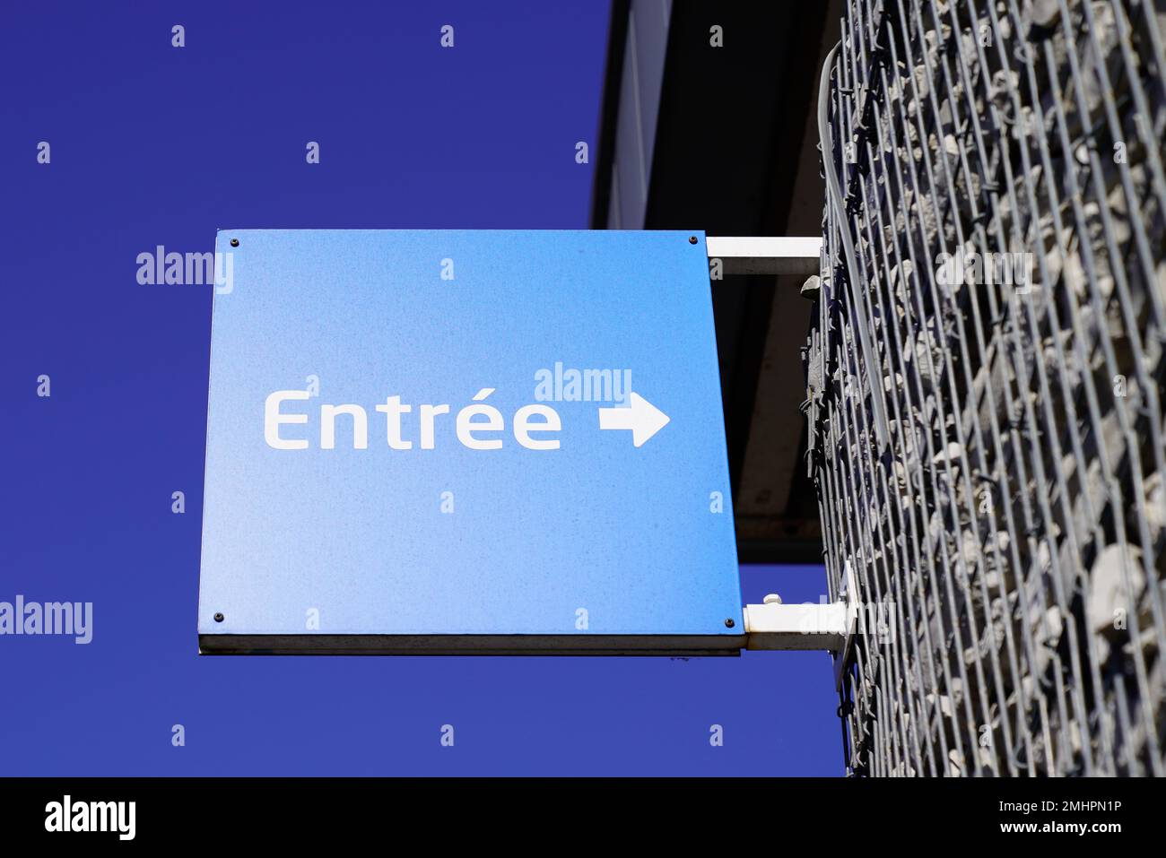 blue sign indicating entree in french text means entry with white arrow