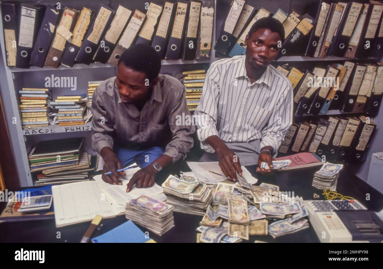 Zambia, Mangu. Bookkeeper is counting the cash money . Stock Photo