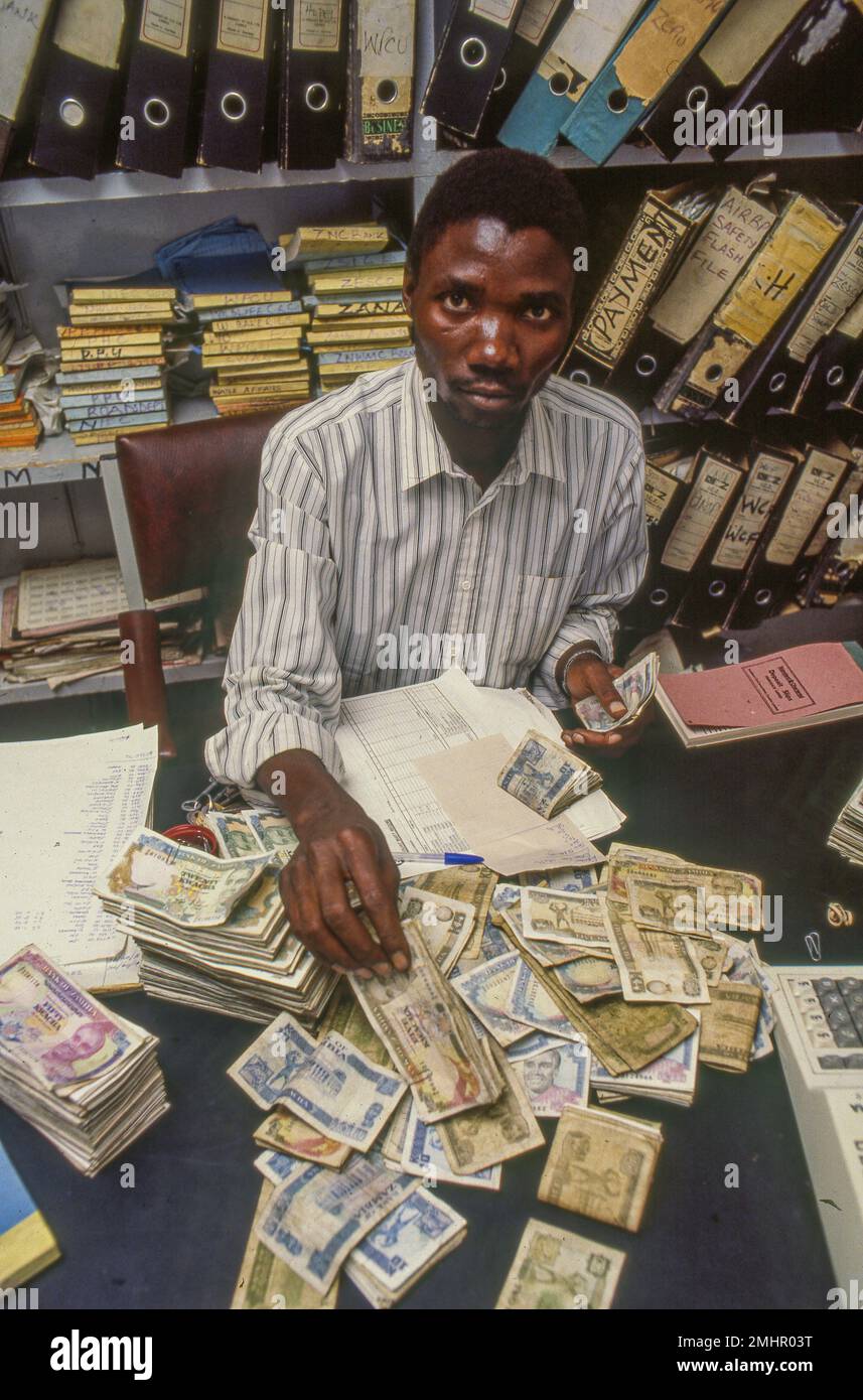 Zambia, Mangu. Bookkeeper is counting the cash money . Stock Photo