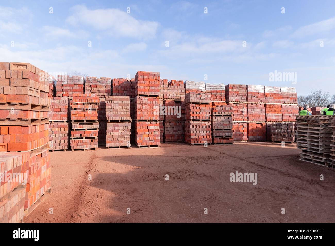 The stacks of red bricks and pallets outdoors on a construction site ...