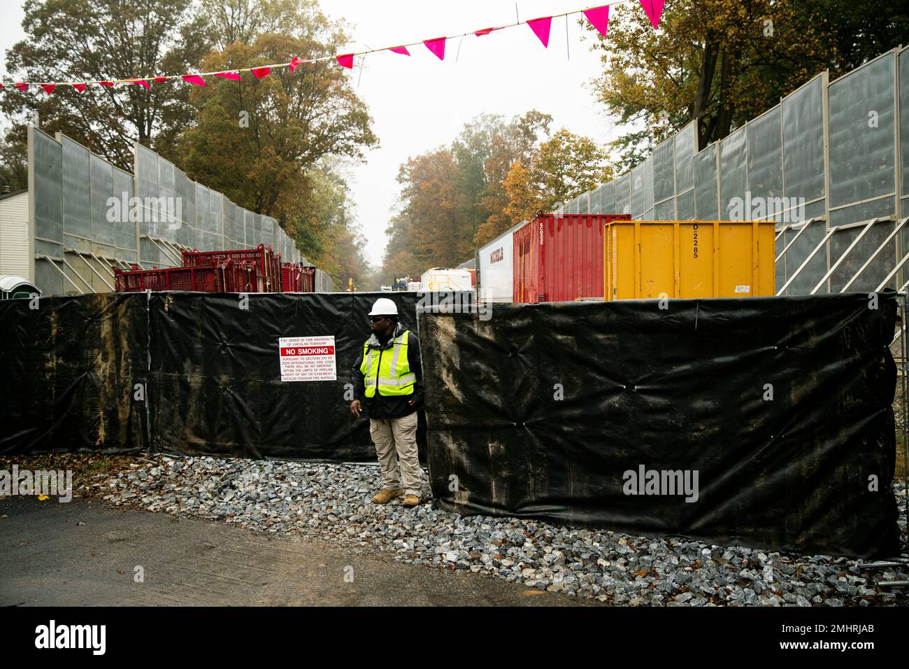 In this Tuesday, Oct. 22, 2019 photo, a worker stands by the gate of a
