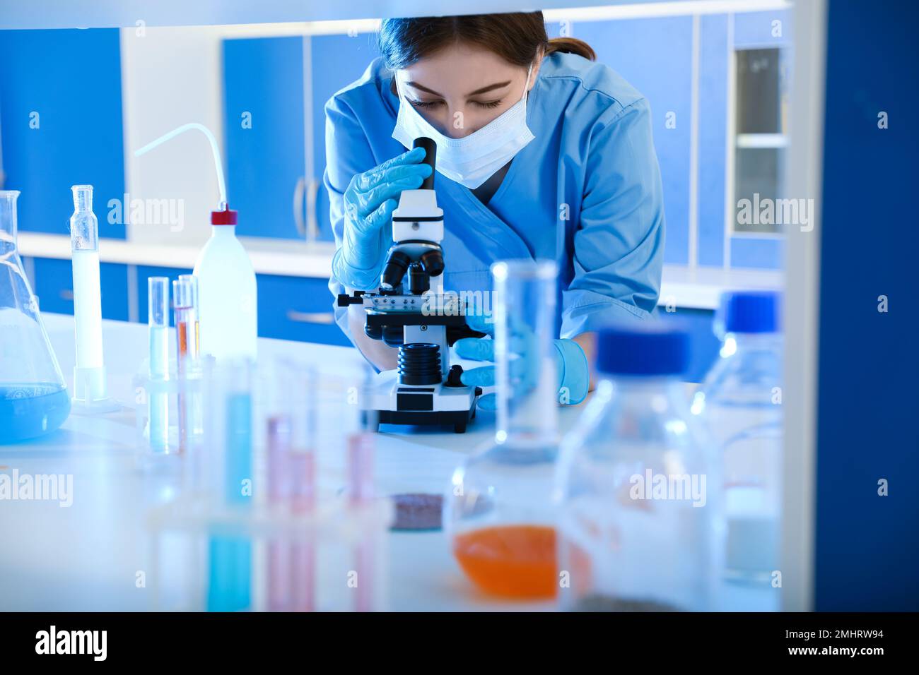 Scientist working with microscope indoors. Laboratory analysis Stock Photo Alamy