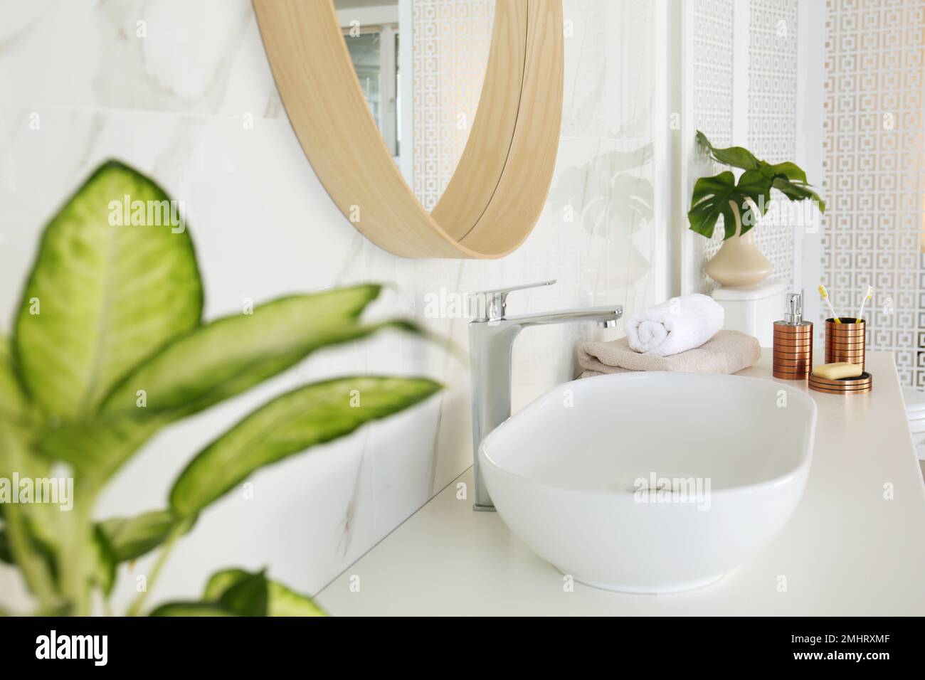 Round mirror over sink in stylish bathroom Stock Photo Alamy