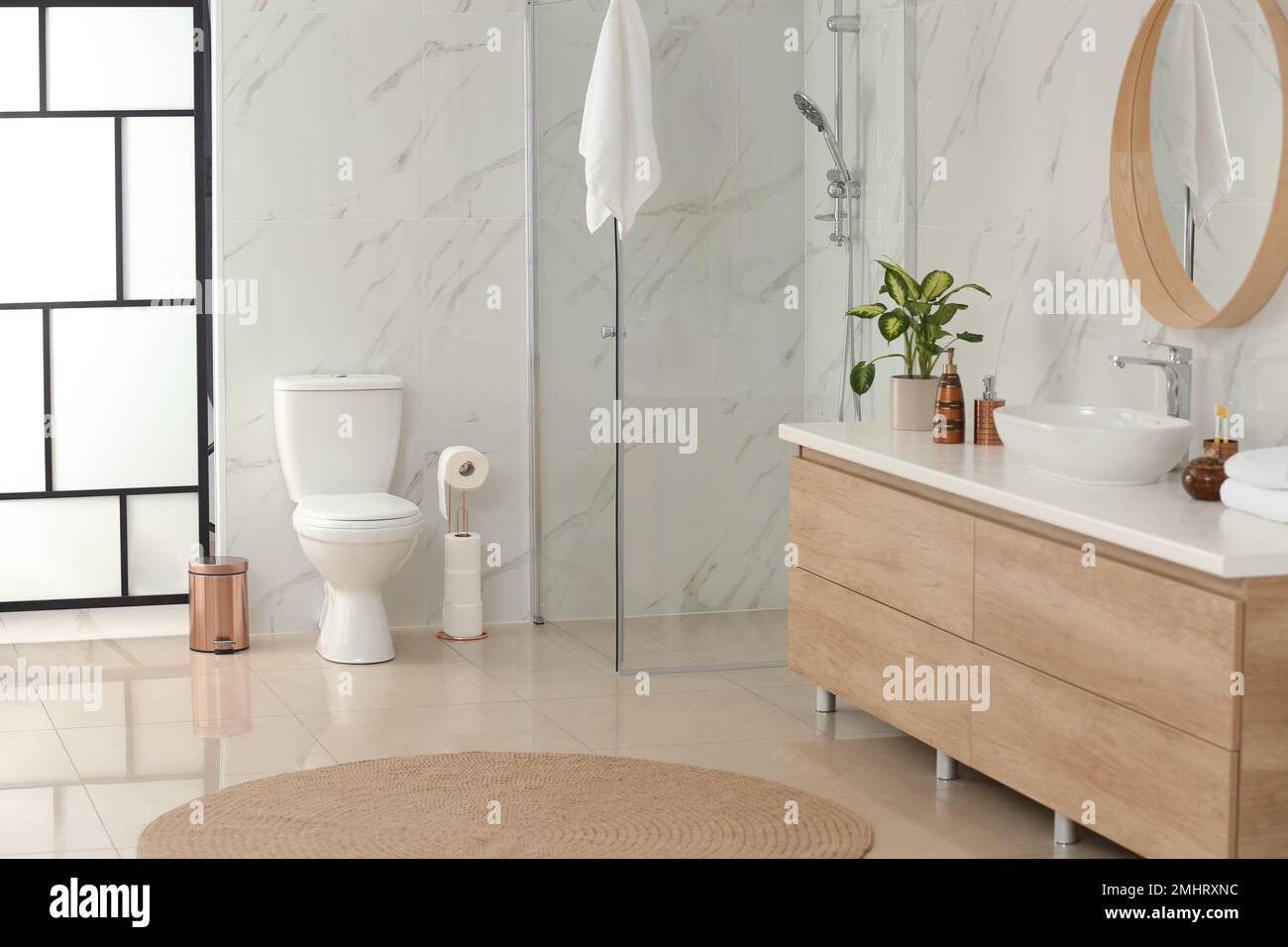Interior of modern bathroom with toilet bowl Stock Photo - Alamy