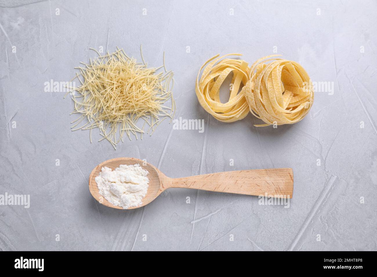 Flat lay composition with pasta on light grey table Stock Photo - Alamy