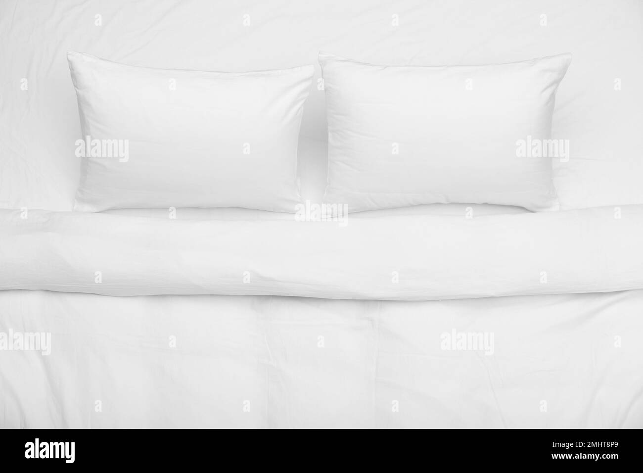 Soft white pillows and blanket on bed, top view Stock Photo Alamy