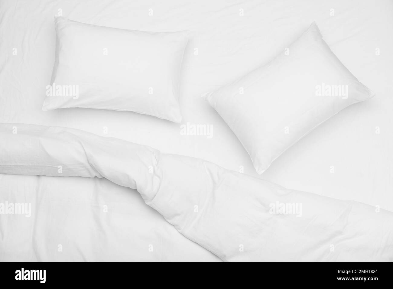 Soft white pillows and blanket on bed, top view Stock Photo Alamy