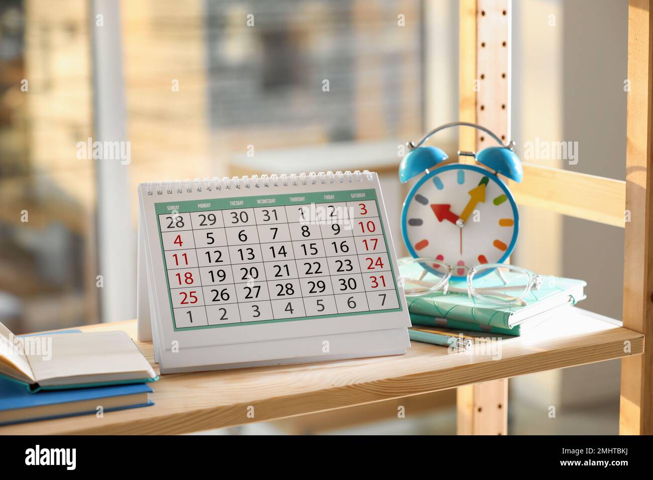 paper-calendar-and-alarm-clock-on-wooden-shelf-indoors-stock-photo-alamy