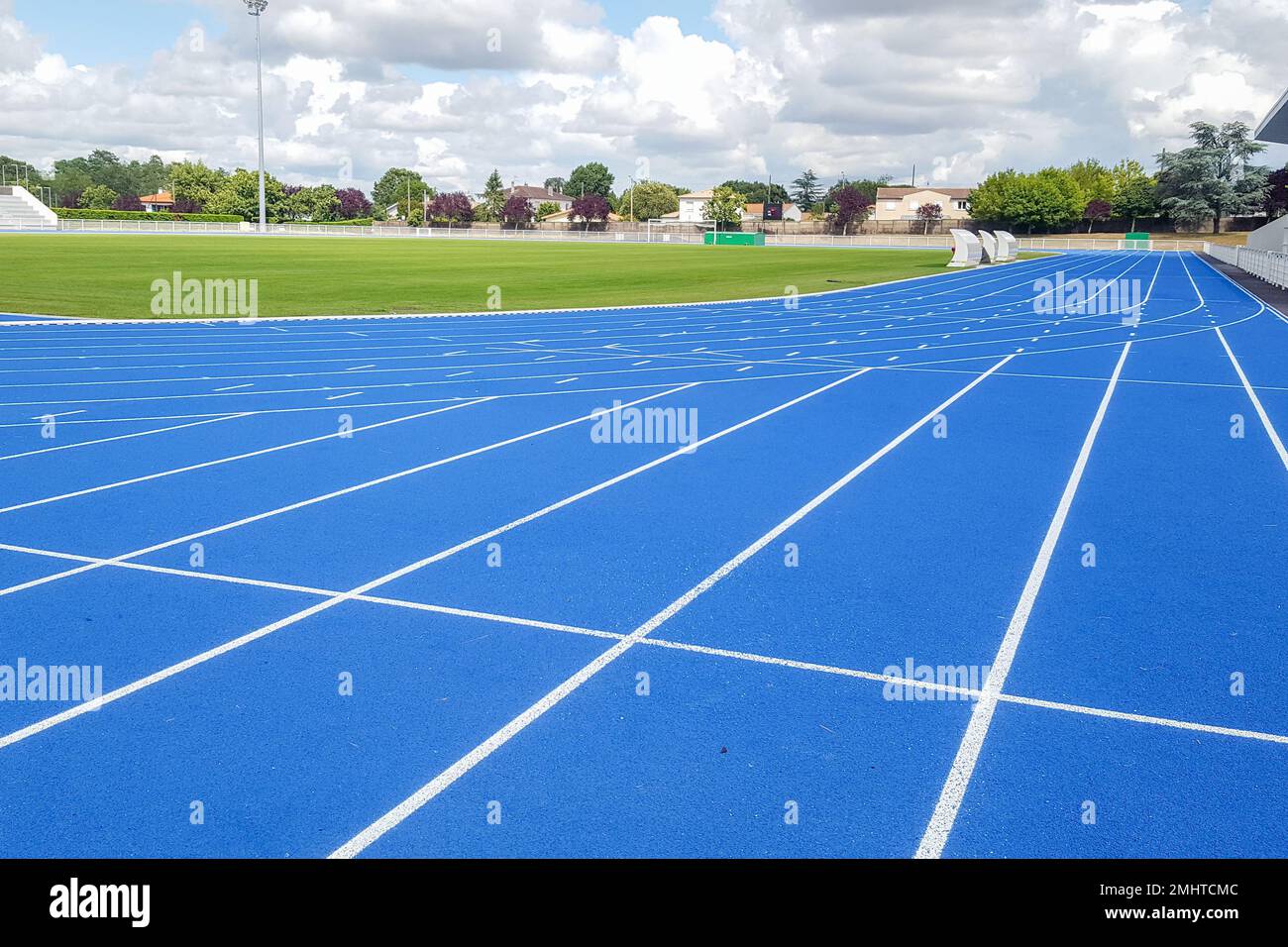 Athletics running track blue treadmill in sport stadium field Stock