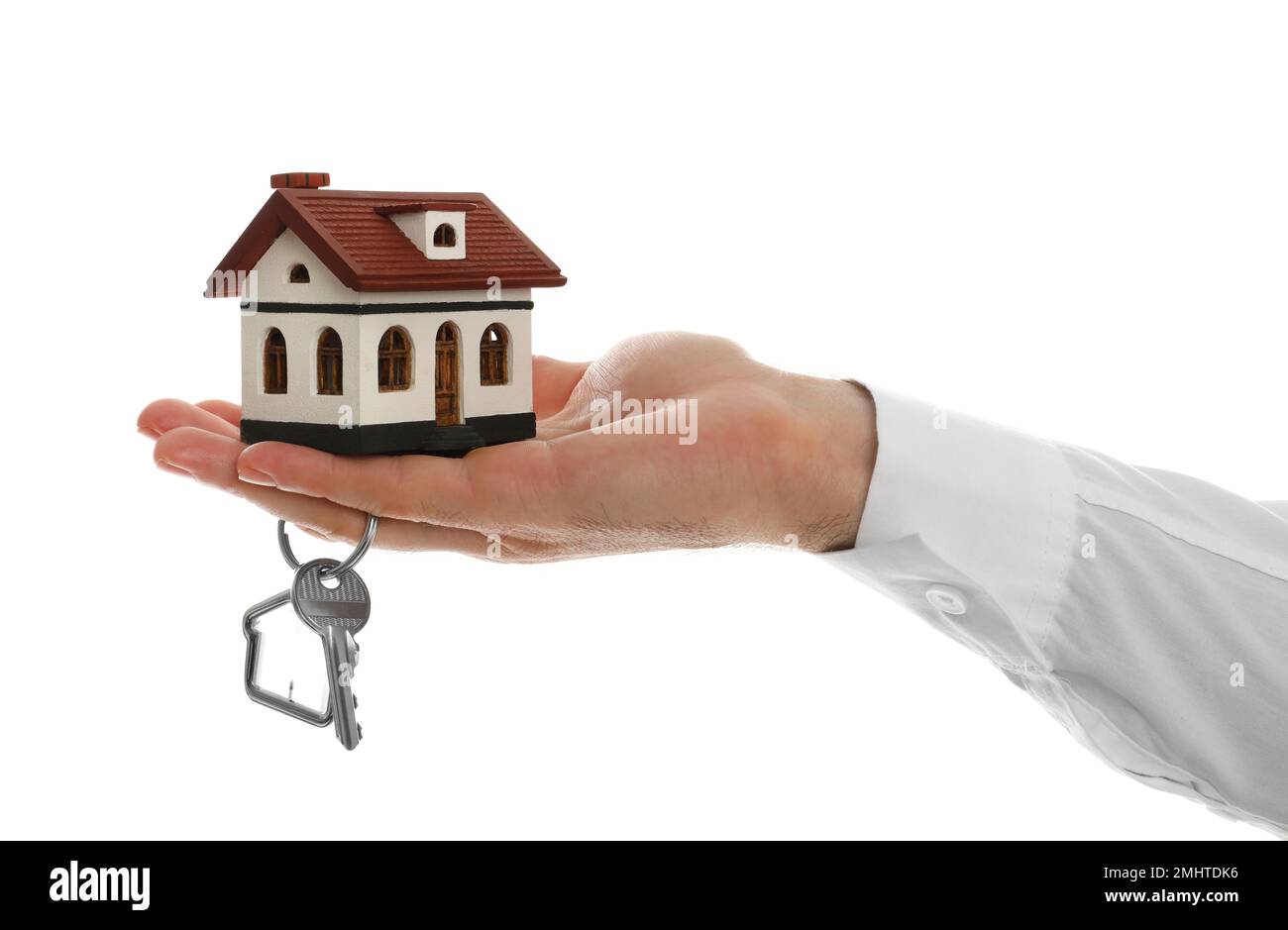 Real estate agent holding house model and key on white background ...
