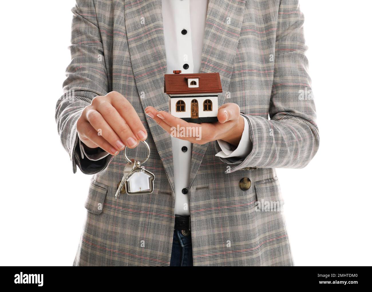 Real estate agent holding house model and key on white background ...