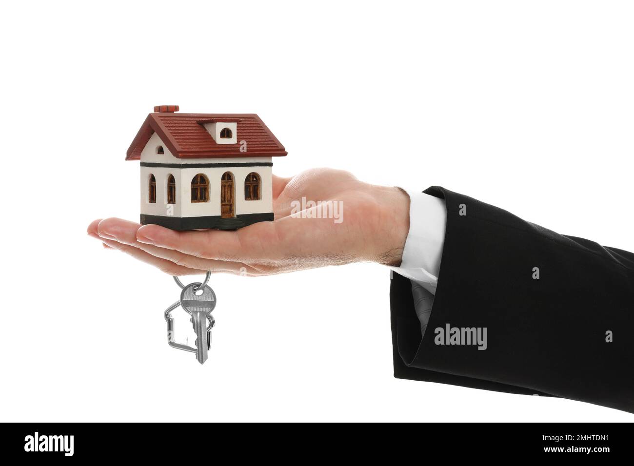 Real estate agent holding house model and key on white background ...