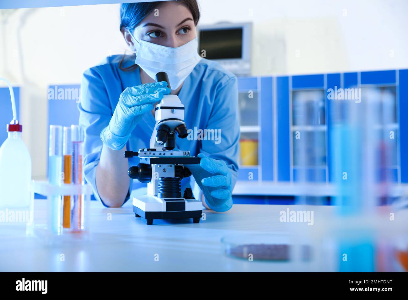 Scientist working with microscope indoors. Laboratory analysis Stock Photo