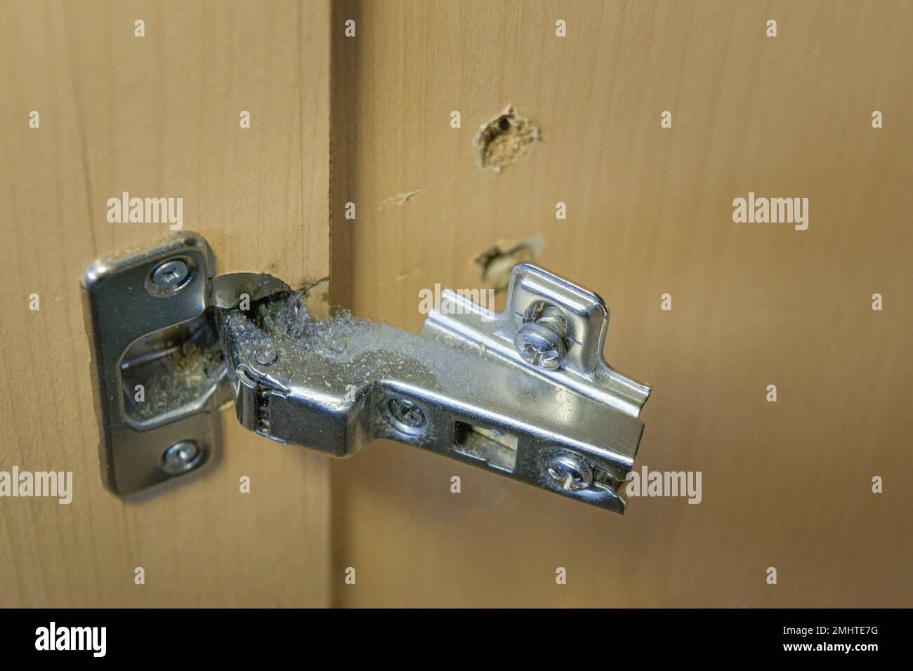 Broken furniture fittings in the linen closet. Close-up with details Stock Photo