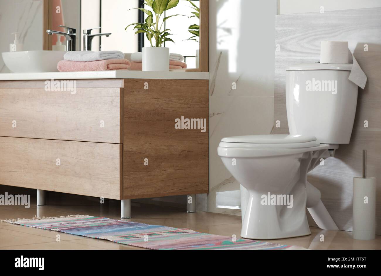 Interior of modern bathroom with toilet bowl Stock Photo - Alamy