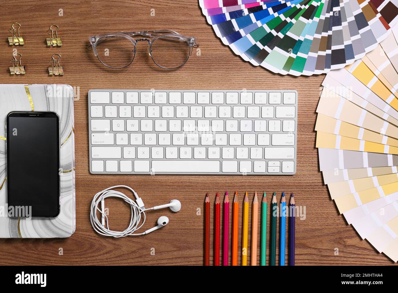 Flat lay composition with wireless keyboard on wooden table. Designer's workplace Stock Photo