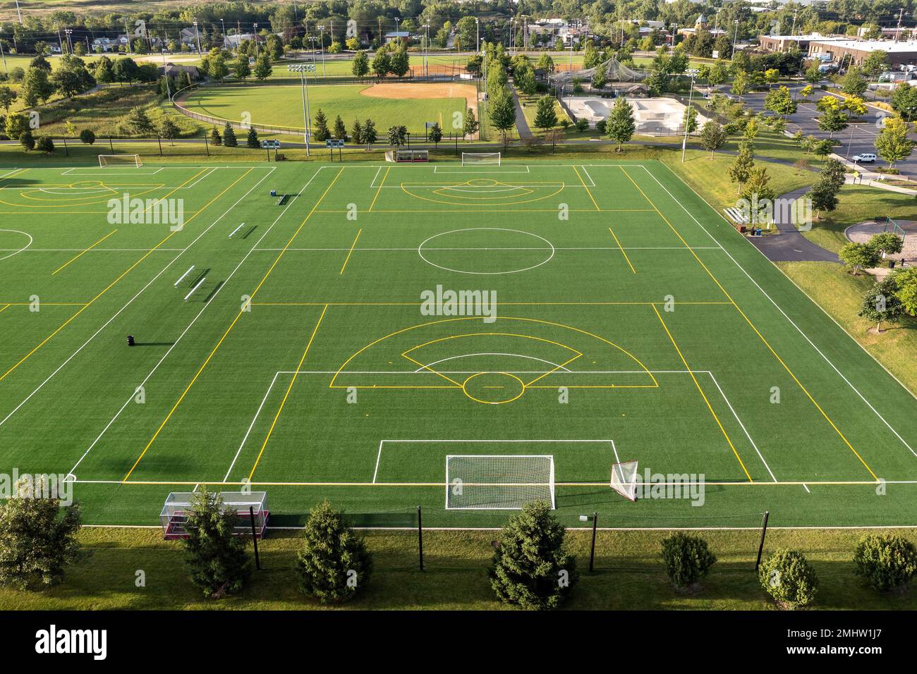 Aerial view of a sports complex with baseball/softball diamonds, artificial turf soccer and lacrosse field, a skate park and batting cages. Stock Photo