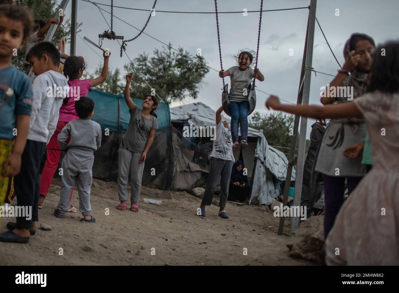 In this Friday Oct. 4, 2019 photo, children play near swings at the Moria  refugee and migrant camp on the Greek island of Lesbos. Greece's eastern  islands are struggling to cope with
